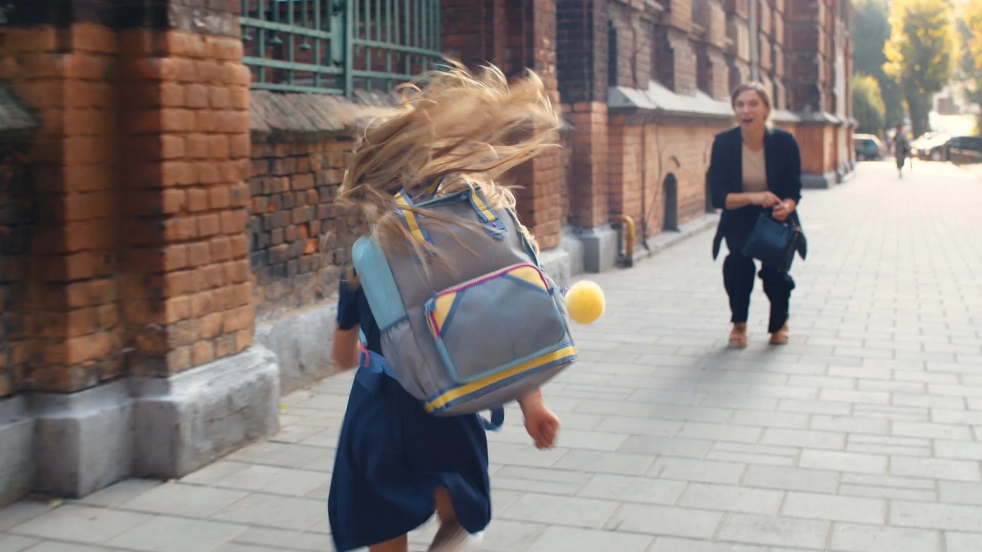 Mother holding her daughter after she had just gotten out of school.